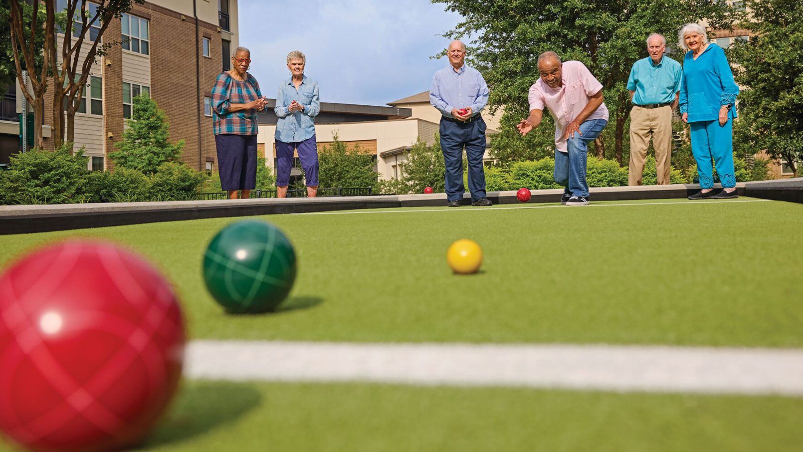 Residents enjoying an outdoor bocce ball court